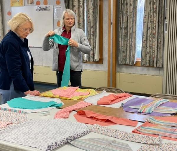Jeannine Young and Pat Lemay check out the fabric combinations.